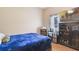 Small bedroom with a single bed, dark wood cabinet, and tile floor at 839 Franconville Ct, Kissimmee, FL 34759