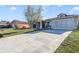 House exterior with a long driveway and neighboring homes at 839 Franconville Ct, Kissimmee, FL 34759