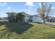 Single story house with a spacious lawn and palm trees at 839 Franconville Ct, Kissimmee, FL 34759
