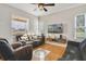 Living room features two sofas, a TV, and tiled floors at 839 Franconville Ct, Kissimmee, FL 34759
