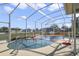 Inviting screened pool with a volleyball net and basketball hoop at 839 Franconville Ct, Kissimmee, FL 34759