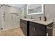 Modern bathroom with double vanity, large mirror, and walk-in shower at 1660 Killean Ct, Apopka, FL 32712