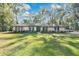 House exterior showcasing a manicured lawn and mature trees at 1660 Killean Ct, Apopka, FL 32712