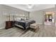 Main bedroom with wood-look floors, sliding doors to patio, and en-suite bathroom at 1660 Killean Ct, Apopka, FL 32712