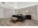 Main bedroom with wood-look floors and ceiling fan at 1660 Killean Ct, Apopka, FL 32712