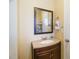 Simple bathroom vanity with granite countertop and a framed mirror at 2007 Disney Mgm Studio Ct, Kissimmee, FL 34746
