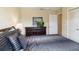 Comfortable bedroom with dark wood dresser and striped bedding at 2007 Disney Mgm Studio Ct, Kissimmee, FL 34746