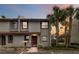Two-story condo with a red door and palm trees in front at 2007 Disney Mgm Studio Ct, Kissimmee, FL 34746