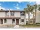 Two-story condo with a red door and palm trees in front at 2007 Disney Mgm Studio Ct, Kissimmee, FL 34746