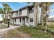 Two-story condo with a red door and walkway at 2007 Disney Mgm Studio Ct, Kissimmee, FL 34746