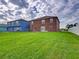 Spacious backyard with green lawn and two-story home at 224 Fairfield Dr, Sanford, FL 32771