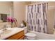 Clean bathroom with shower/tub combo, wood vanity, and geometric shower curtain at 224 Fairfield Dr, Sanford, FL 32771