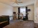 Bright bedroom with workspace setup, window coverings, and carpeted floor at 224 Fairfield Dr, Sanford, FL 32771