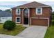 Two-story brown house with a two-car garage and landscaping at 224 Fairfield Dr, Sanford, FL 32771