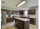 Modern kitchen with dark cabinets, quartz countertops, and an island at 224 Fairfield Dr, Sanford, FL 32771