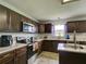 Modern kitchen with dark cabinets, quartz countertops, and an island at 224 Fairfield Dr, Sanford, FL 32771