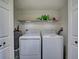 Laundry room with side-by-side washer and dryer, and overhead shelving at 224 Fairfield Dr, Sanford, FL 32771