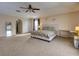 Main bedroom with carpeted floors, king-size bed, and walk-in closet at 224 Fairfield Dr, Sanford, FL 32771