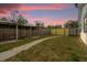 Fenced backyard with a curved walkway and wooden structures at 2762 Hilda Cv, Winter Park, FL 32792