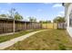 Fenced backyard with a curved walkway and wooden structures at 2762 Hilda Cv, Winter Park, FL 32792