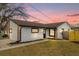 Updated house exterior boasts a fresh coat of paint and landscaping at 2762 Hilda Cv, Winter Park, FL 32792