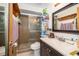 Bathroom features a vanity with dark wood cabinets and a shower at 2825 Beal St, Deltona, FL 32738