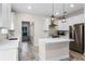 Modern kitchen with white cabinets and a large island at 456 Baron Rd, Orlando, FL 32828