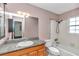 Clean bathroom with granite countertop vanity, shower/tub combo, and window at 5724 Se 2Nd St, Ocala, FL 34480
