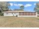 Back exterior view showing house, screened porch and yard at 5724 Se 2Nd St, Ocala, FL 34480
