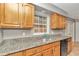 Kitchen with granite countertops, oak cabinets, and a double sink at 5724 Se 2Nd St, Ocala, FL 34480