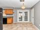 Kitchen with wood cabinets, granite countertops, and French doors to patio at 5724 Se 2Nd St, Ocala, FL 34480