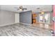 Living room with grey walls, wood-look floors and a view into the kitchen at 5724 Se 2Nd St, Ocala, FL 34480