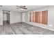 Living room featuring grey walls, wood-look floors, and a view to the front door at 5724 Se 2Nd St, Ocala, FL 34480
