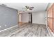 Living room with grey walls, wood-look floors, and access to other rooms at 5724 Se 2Nd St, Ocala, FL 34480