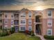 Tan two-story building with stairs and landscaping at 580 Brantley Terrace Way # 203, Altamonte Springs, FL 32714