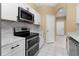 Modern kitchen with stainless steel appliances and white cabinets at 580 Brantley Terrace Way # 203, Altamonte Springs, FL 32714