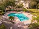 Community pool with lounge chairs and patio tables at 580 Brantley Terrace Way # 203, Altamonte Springs, FL 32714