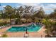 Community pool with surrounding patio furniture at 580 Brantley Terrace Way # 203, Altamonte Springs, FL 32714