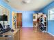 Blue bedroom with wood floors, showing a doorway and bathroom at 621 Hill Avenue, Ocoee, FL 34761