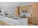 Modern kitchen with light wood cabinets and a large quartz island at 6491 Octave St, Mascotte, FL 34753
