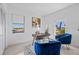 Bright home office with two blue chairs and wood desk at 6491 Octave St, Mascotte, FL 34753