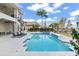 Luxury pool with spa and lake view; spacious patio with lounge chairs at 7811 Skiing Way, Winter Garden, FL 34787