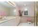 Bathroom with double vanity, bathtub, and updated fixtures at 104 Coventry Ln, Haines City, FL 33844