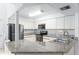 Galley-style kitchen with stainless steel appliances and granite countertops at 104 Coventry Ln, Haines City, FL 33844