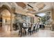 Elegant dining room with a large chandelier and wine wall at 11103 Bridge House Rd, Windermere, FL 34786
