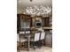Spacious kitchen with island seating, stainless steel appliances, and a stunning chandelier at 11103 Bridge House Rd, Windermere, FL 34786