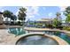 Luxury pool and spa with ample lounge chairs and lake view at 11103 Bridge House Rd, Windermere, FL 34786