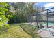 Screened pool and patio area, surrounded by a grassy backyard at 112 Blackwater Ct, Kissimmee, FL 34743