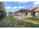 Spacious backyard with a screened-in pool at 112 Blackwater Ct, Kissimmee, FL 34743