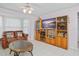 Living room with wood entertainment center and flat screen TV at 112 Blackwater Ct, Kissimmee, FL 34743